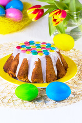 Easter cake with white glaze on a yellow plate
