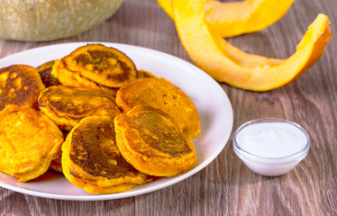 fritters with pumpkin on a beige plate