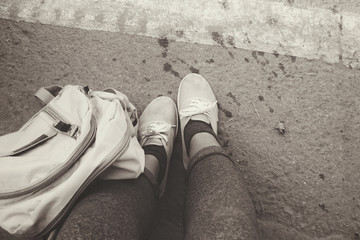 Selfie of woman tourist with a backpack standing on road
