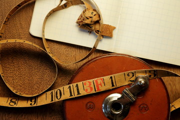 Vintage background viewed from above. Old measuring tape, notebook and equipment.