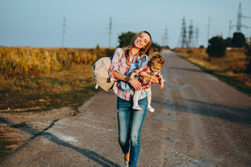 mother and daughter on a field with pumpkins