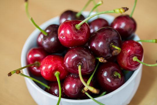 Red Fruit, Handful of a red cherry in a cup