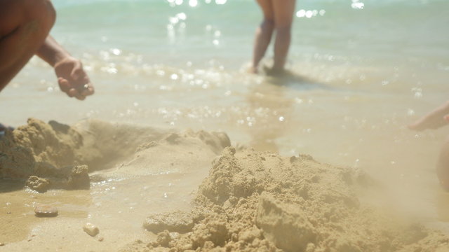 Child destroys sand castles.