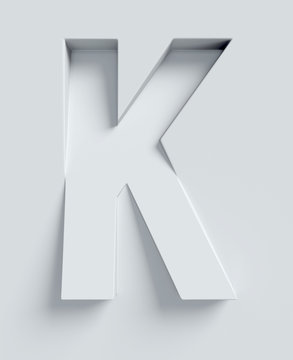 Letter K slanted 3d font engraved and extruded from the surface