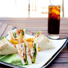 Club sandwich with iced soda drink