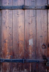 Fototapeta premium Old wooden dark brown door with metal details