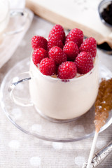 Yogurt with fresh raspberries, bread, tea