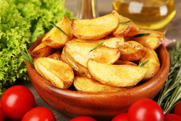 Baked potato wedges on table, closeup