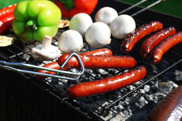 Sausages and vegetables on grill closeup