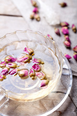 Rose buds herbal tea in a glass cup