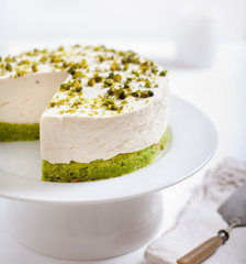 Pistachio cheesecake, mousse cake on a white plate