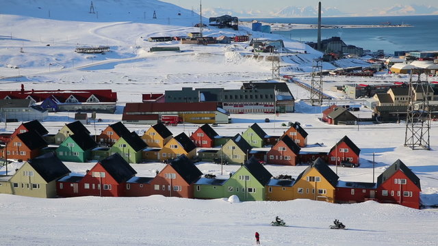 Small town Longyearbyen among snow-capped mountains of the Norwegian archipelago of Svalbard in early spring.