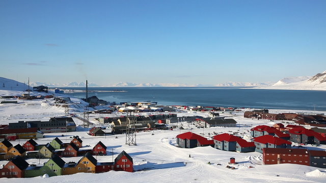 Small town Longyearbyen on the shores of the Arctic Ocean among snow-capped mountains of the Norwegian archipelago of Svalbard.