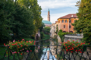 View of Retrone river and the clock tower of Vicenza, Italy, seen from Furo bridge