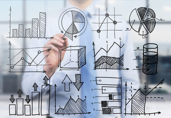 Quantitative analyst is drawing different charts on the glass screen. A concept of professional...