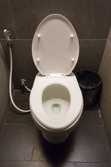 Clean white toilet inside man restroom