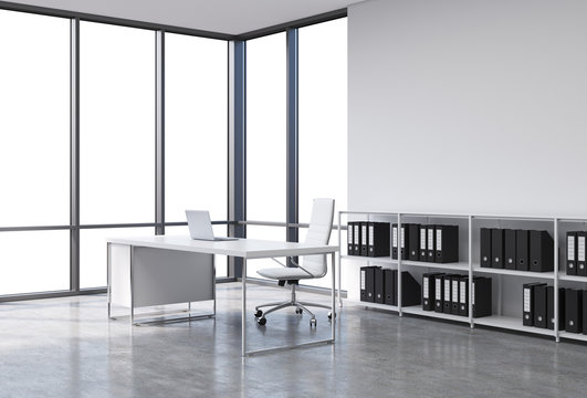 A workplace in a modern corner panoramic office with copy space in the windows. A white desk with a laptop, white leather chair and a bookshelf with black document folders. 3D rendering.
