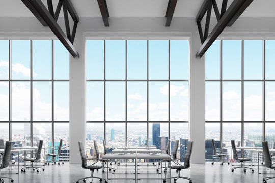 Modern workplaces in a modern bright clean interior of a loft style office. Huge windows with New York panoramic view. White desks equipped with laptops, black leather chairs. 3D rendering.