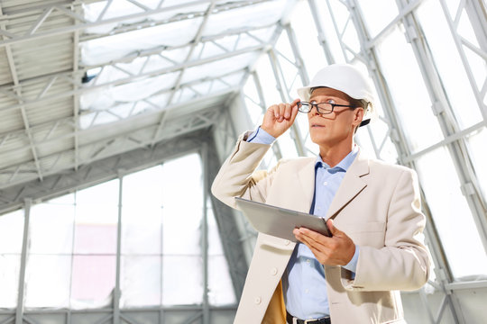 Pleasant architect holding laptop 