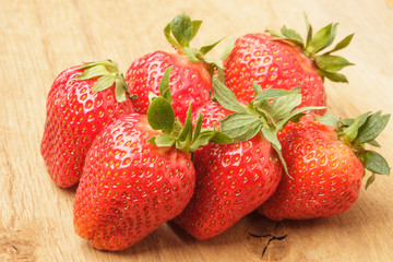 Red fresh strawberry fruits on wooden table.