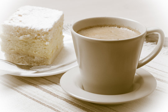 cup with coffee and cake on table