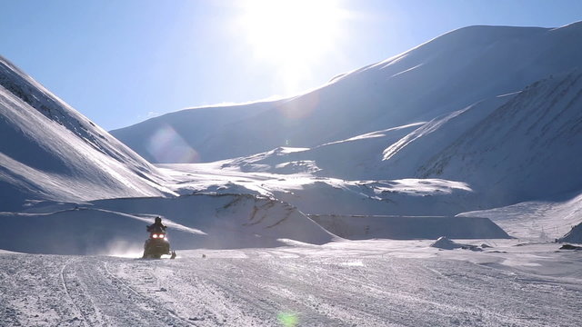 A group of snowmobiles on the background of a snowy landscape at Svalbard Norway