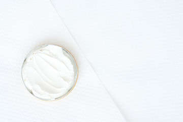 Fototapeta na wymiar white cream in a bowl on white textured background - studio sho
