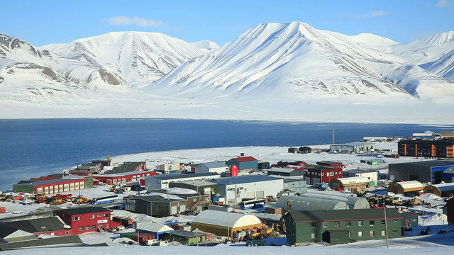 Small town Longyearbyen on the shores of the Arctic ocean among snow-capped mountains of the Norwegian archipelago of Svalbard.