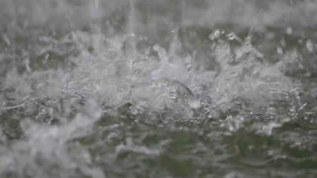 Water splashes on pond surface when rain shooting high speed