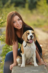 beautiful woman and his dog posing outside