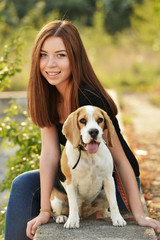 beautiful woman and his dog posing outside