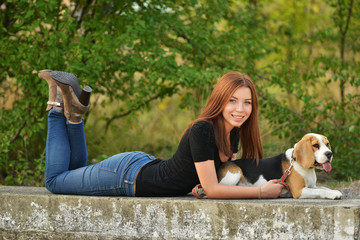 beautiful woman and his dog posing outside