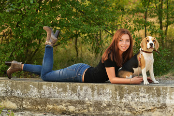 beautiful woman and his dog posing outside