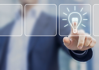 Business idea concept with lightbulb symbol touched by businessm