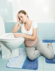 pregnant woman suffering from intoxication and feeling sick