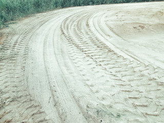 Fototapeta na wymiar Wheel tracks on the soil.