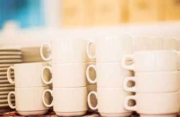 Lot of tea cups stacked one on one, catering on a banquet.