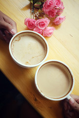 Male and female couple with latte coffee and rose