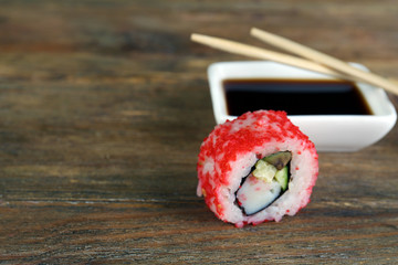 Roll with sauce and sticks on wooden table close up