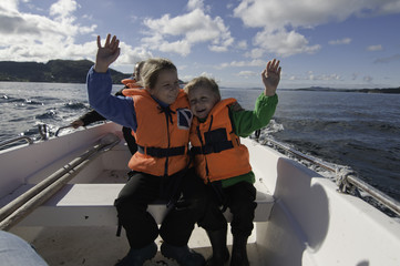 Siblings hugging in a boat