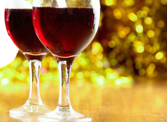 christmass dinner with rose candies and two glasses of red wine