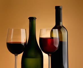 A glass of wine and a bottle