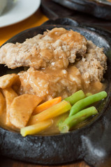 Sirloin steak served with sauce on hot plate