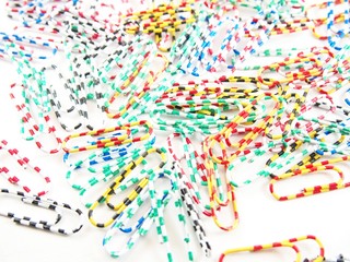 Fototapeta premium Stack of multicolored paper clips, stationery for back to school and equipment in office