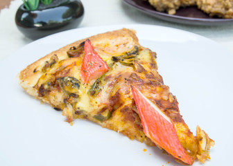 Delicious slice of pizza with seafood