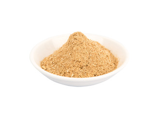 Dried lemongrass powder in a white bowl over white background