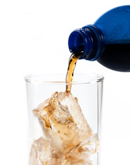 Pouring of cola in the glass with ice,Selective focus on glass