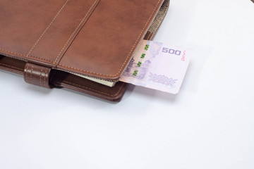 thai baht in the books, isolated on white background