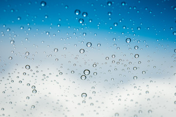 Naklejka na ściany i meble Water drops on glass ,Movement of water drop on glass ,Out of focus water drop movement background for presentation and business