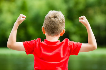 Happy boy with raised arms